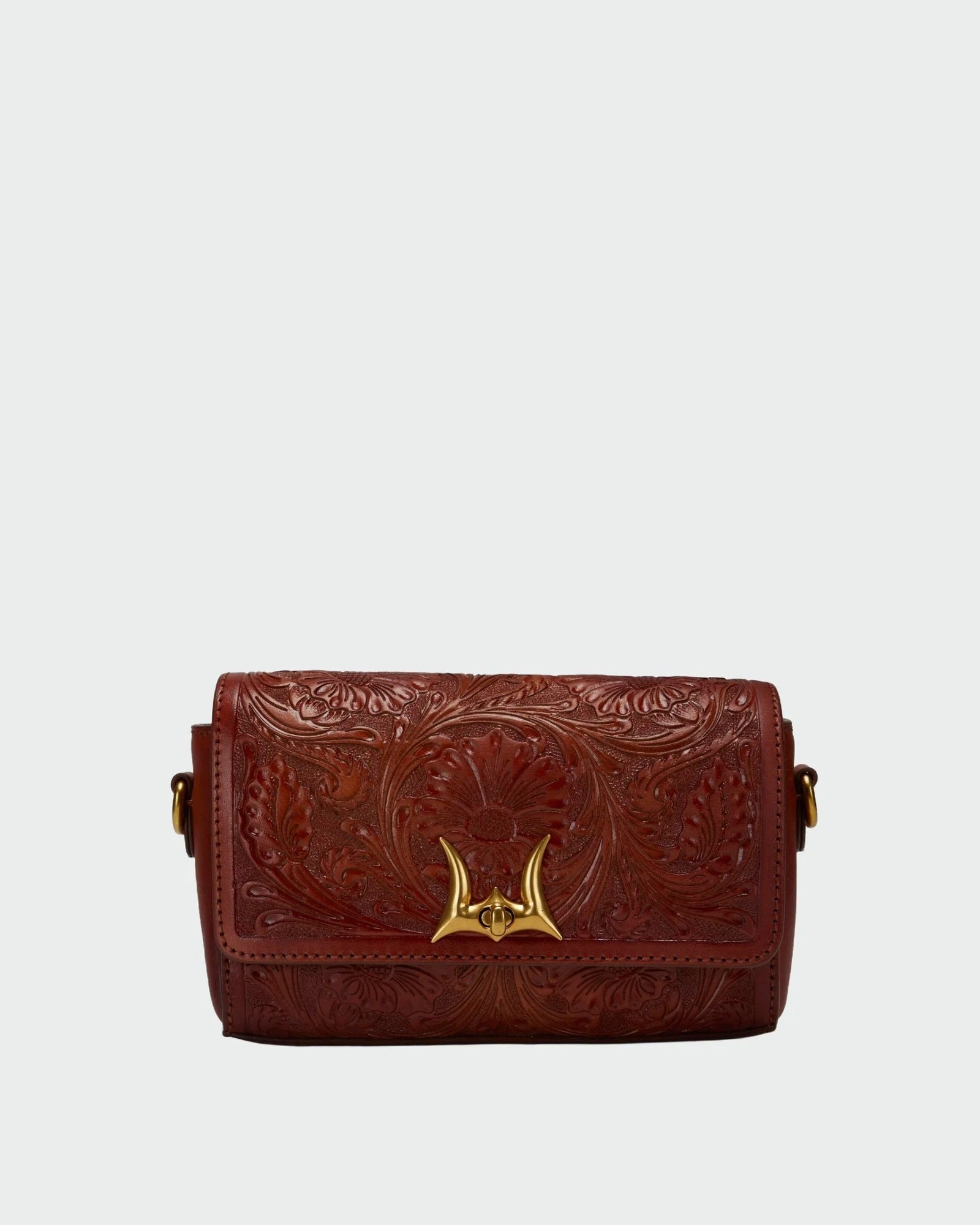 House of Hide genuine leather dark reddish-brown tooled shoulder bag featuring a gold-tone metal clasp on a light gray studio background