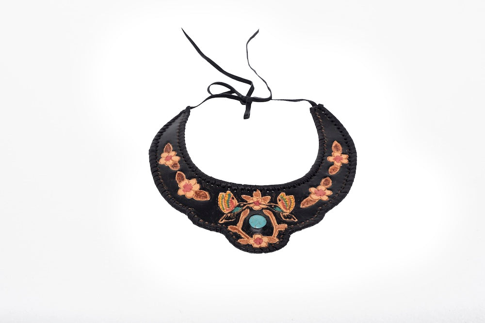 Detailed view of black leather choker featuring hand-tooled and hand-painted floral artwork, tied at the back with a western-boho edge.