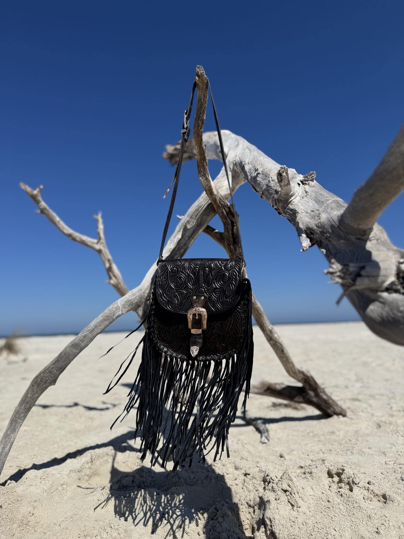 Blackstone Crossbody bag with tassels, captured in a lifestyle setting to show its versatility and western flair.