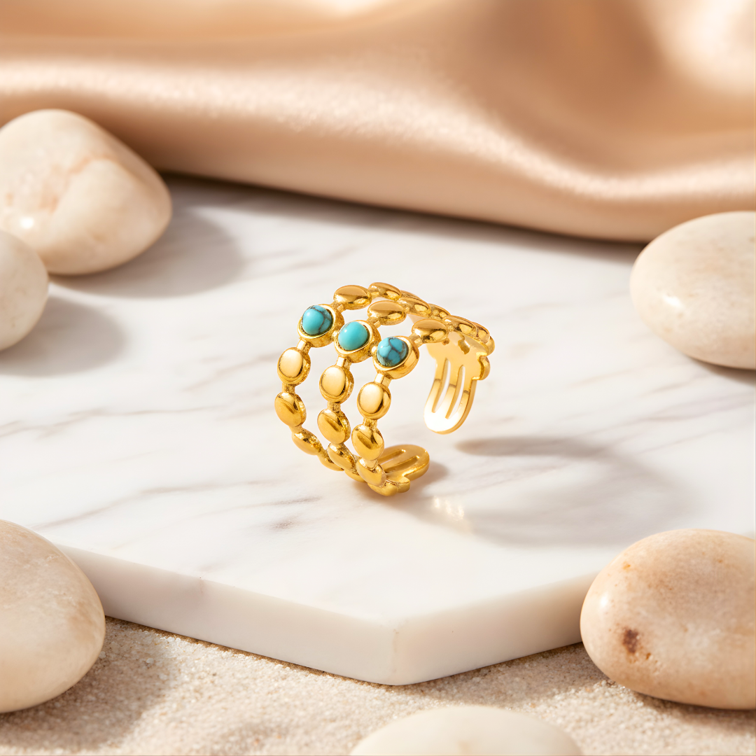 Boho Mystica Ring featuring turquoise gemstones set in gold on white background