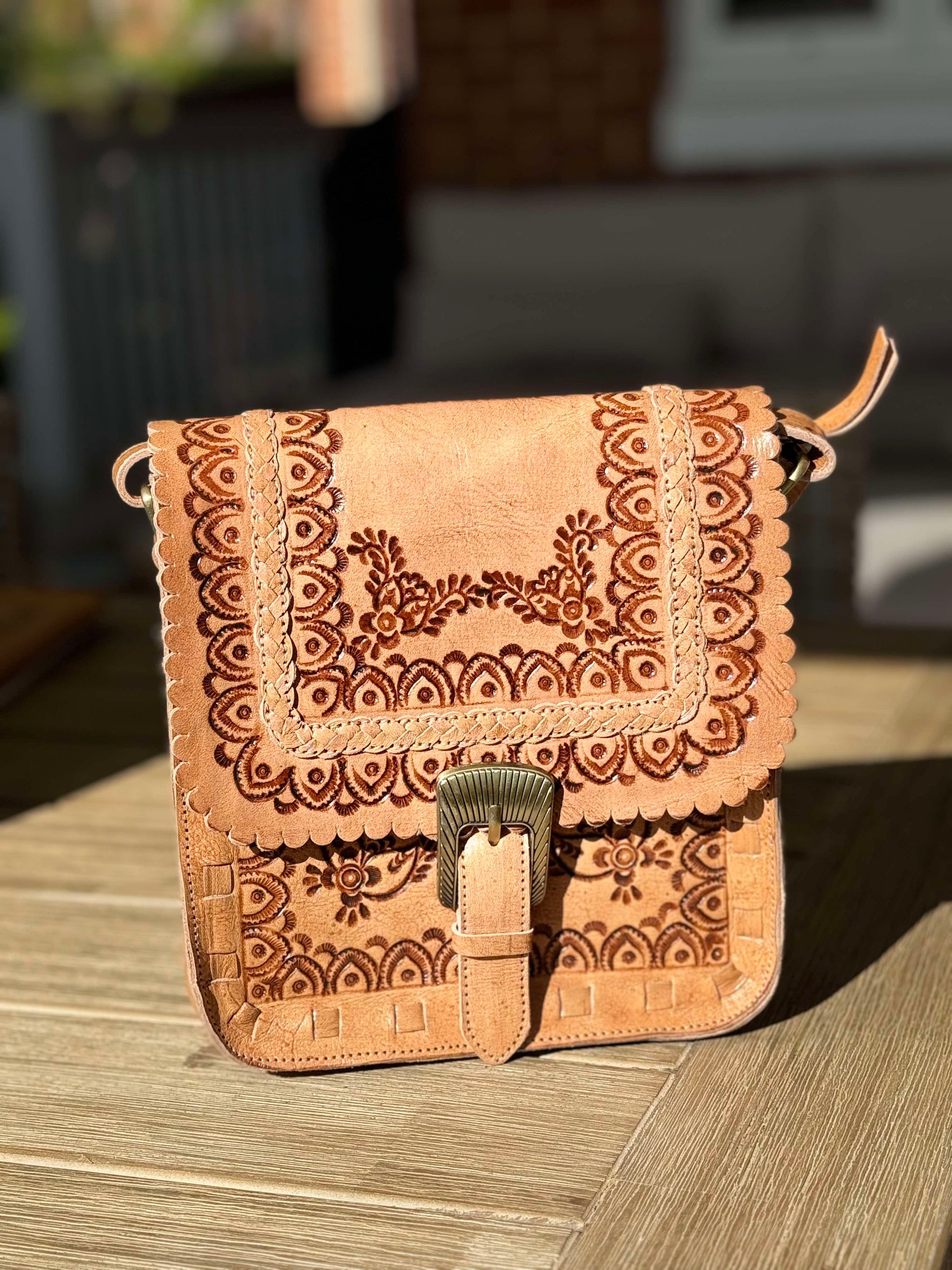 Boho-chic Indie Sky crossbody bag in soft brown leather, adjustable strap, and secure magnetic buckle closure.