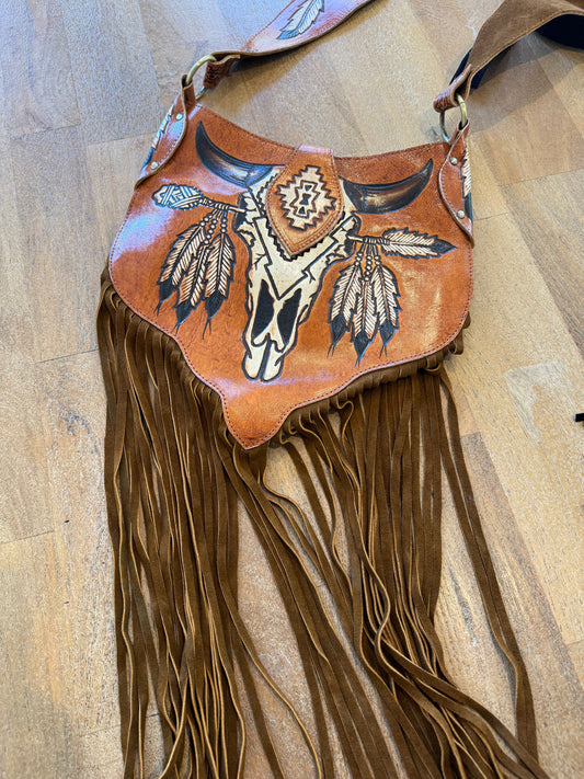 Boho Bronco Bag with intricate carving and tassels, showcasing Western and boho elements.