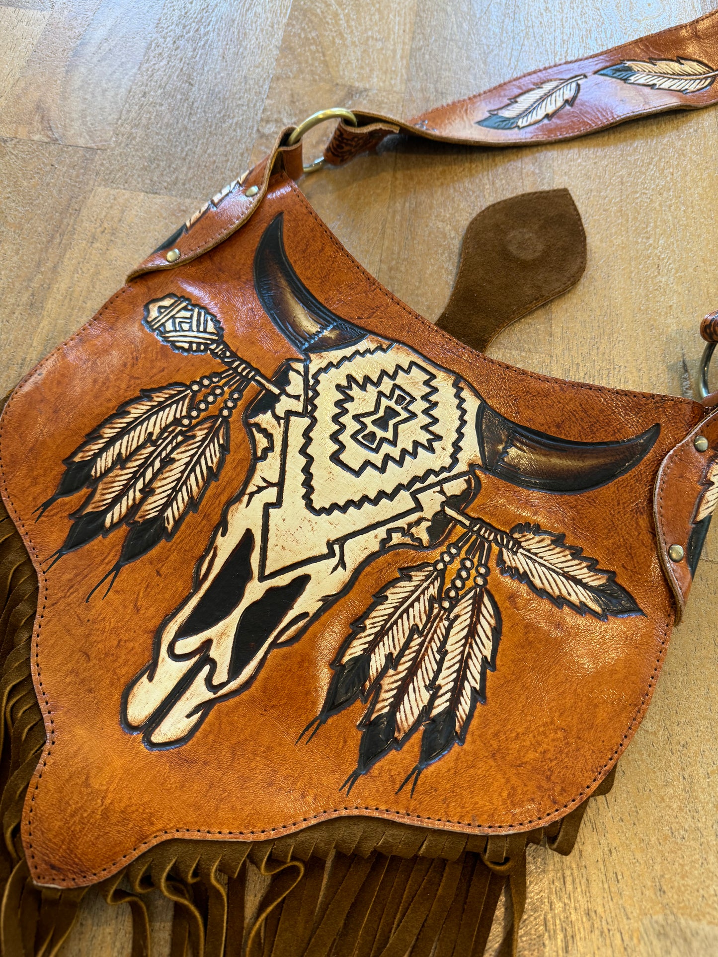 Close-up of intricate carving and tassels on the Boho Bronco Bag – slow fashion meets country chic