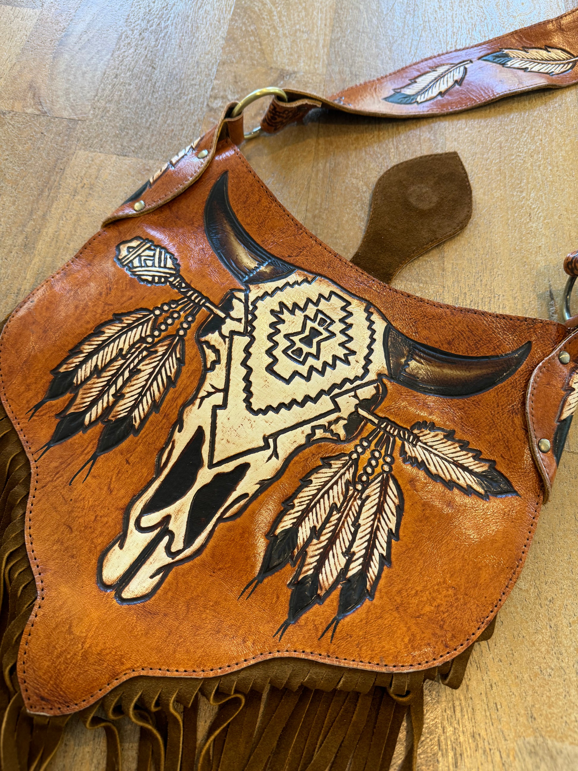 Close-up of intricate carving and tassels on the Boho Bronco Bag – slow fashion meets country chic