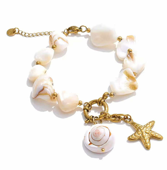 Boho beach-style necklace featuring chunky white shell beads and ocean-inspired gold details