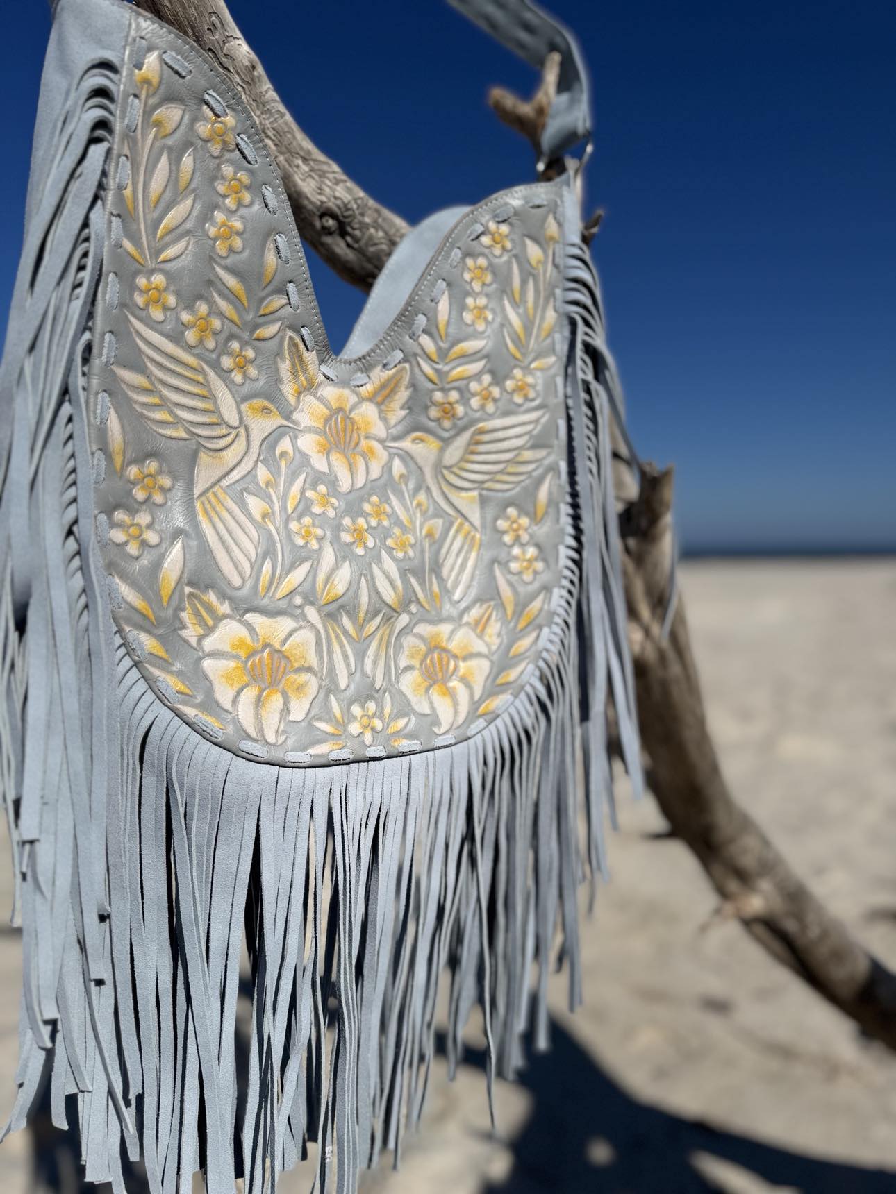 Boho fringe bag: hand-tooled leather with blue and yellow floral details, perfect for summer