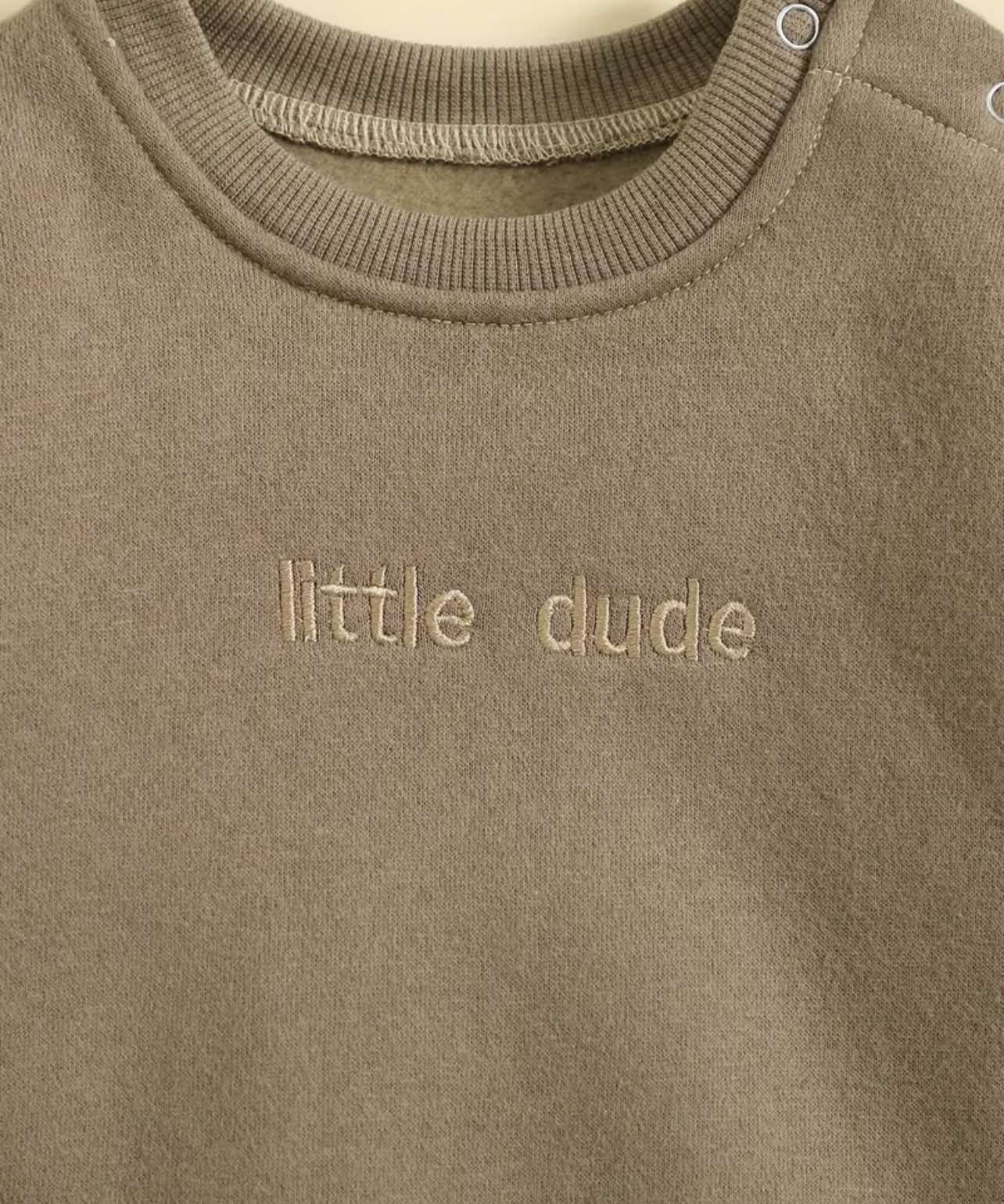 Brown and blue ‘Little Dude’ rompers with cozy fleece lining, available in sizes 0-3 to 18-24 months.