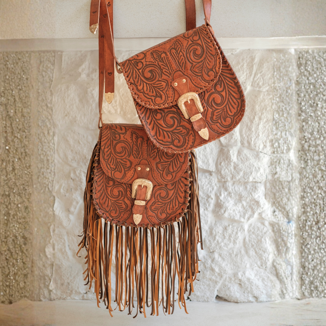 Brown leather Western handbag featuring hand-tooled floral detailing, cascading leather fringe and premium genuine leather craftsmanship.