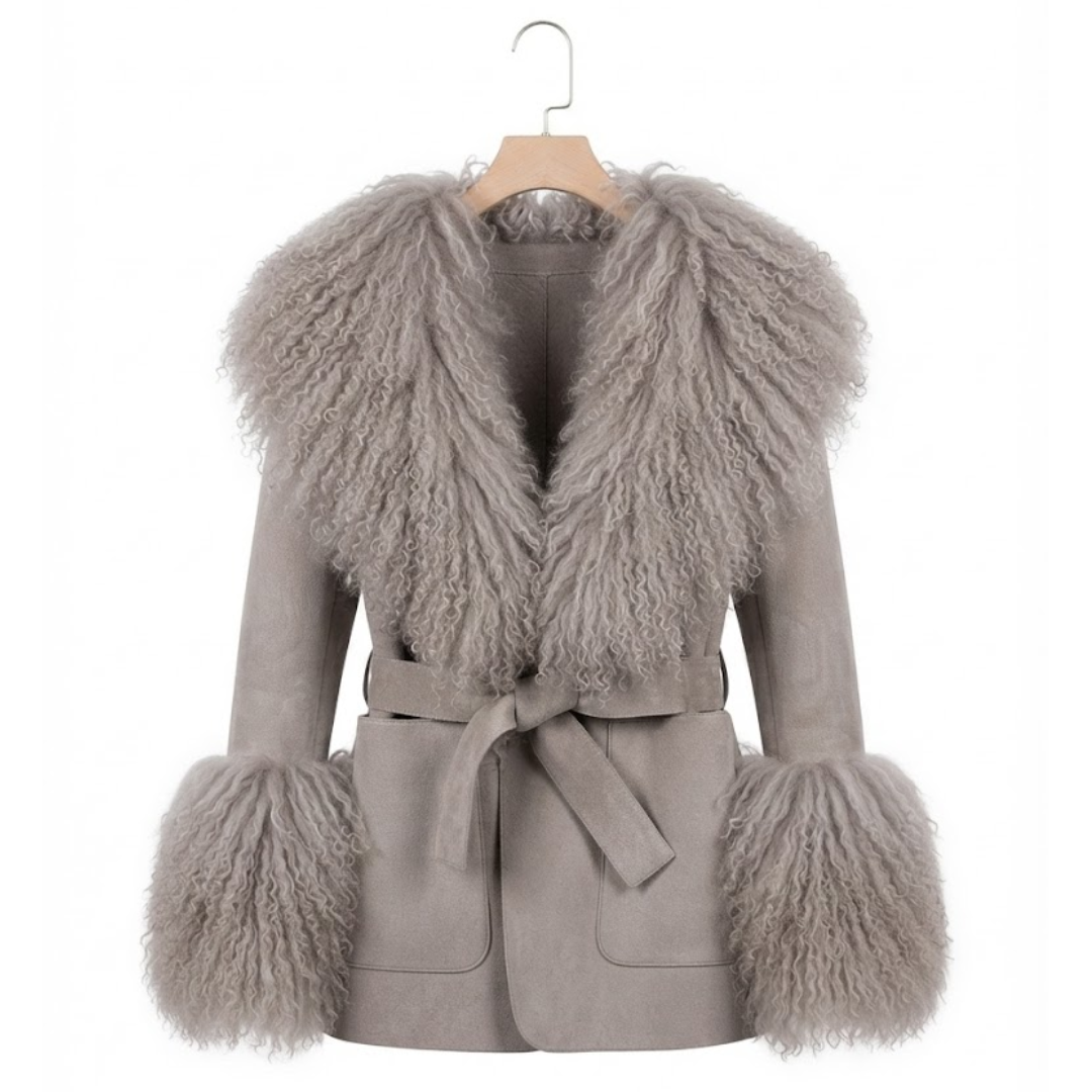 Cashmere Jacket from House of Hide in soft grey wool and cashmere blend with detachable Mongolian sheep fur collar and cuffs, adjustable tie belt for tailored silhouette, patch pockets, long loose trench silhouette being displayed on neutral background