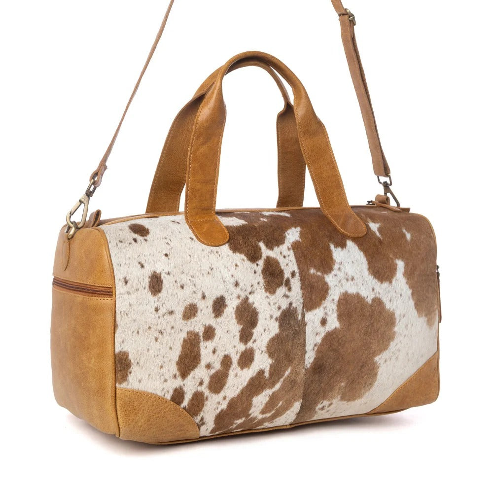 House of Hide genuine leather brown and white cow print duffel bag in western style on a white background