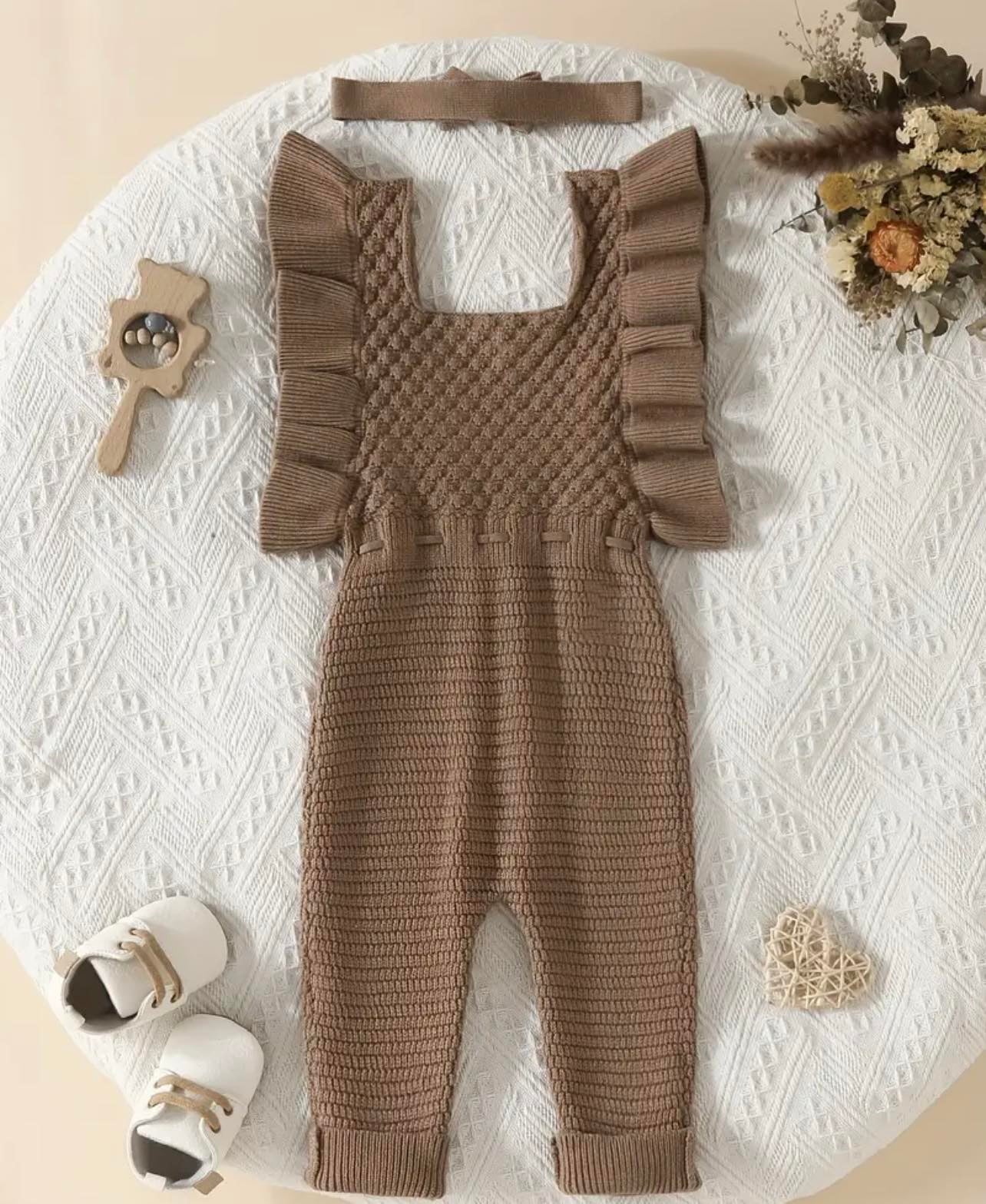Close-up of ruffle off-shoulder detail on chocolate knit jumpsuit