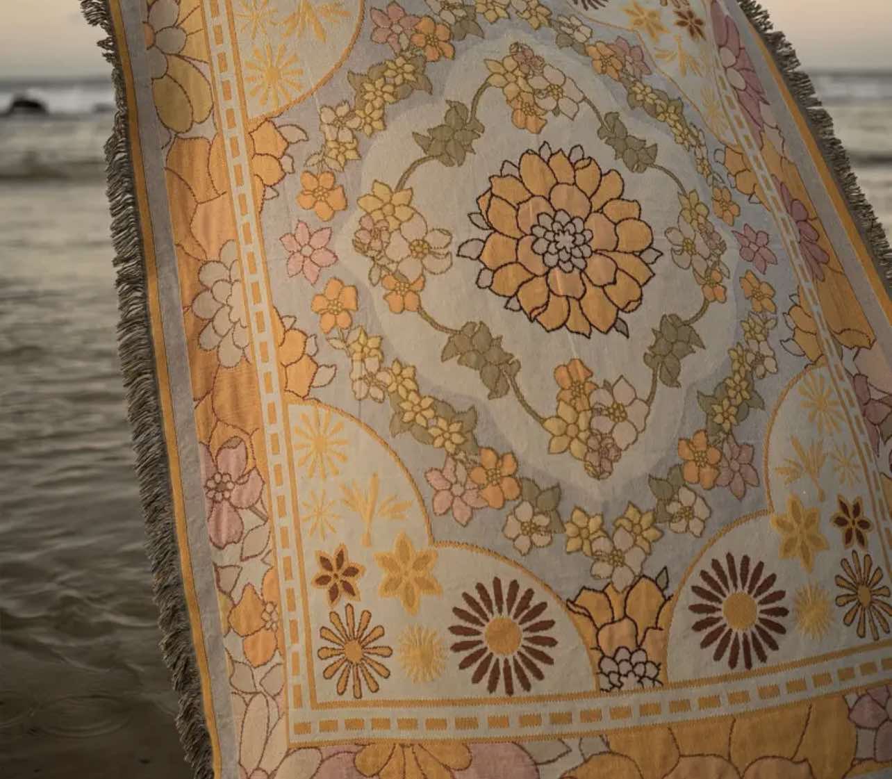 Close-up of the Golden Glow Boho Rug with floral patterns, ideal for a cozy beach picnic blanket
