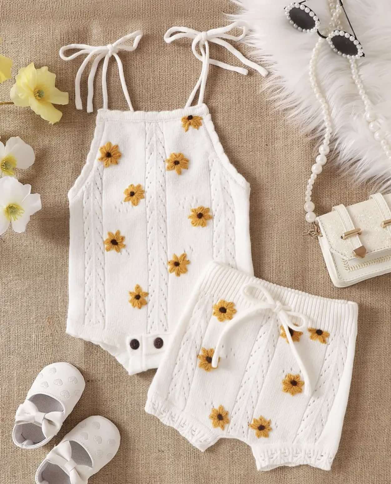 Close-up of the White Sunflower Knit Two-Piece Set with embroidered sunflower details on the white tank top.