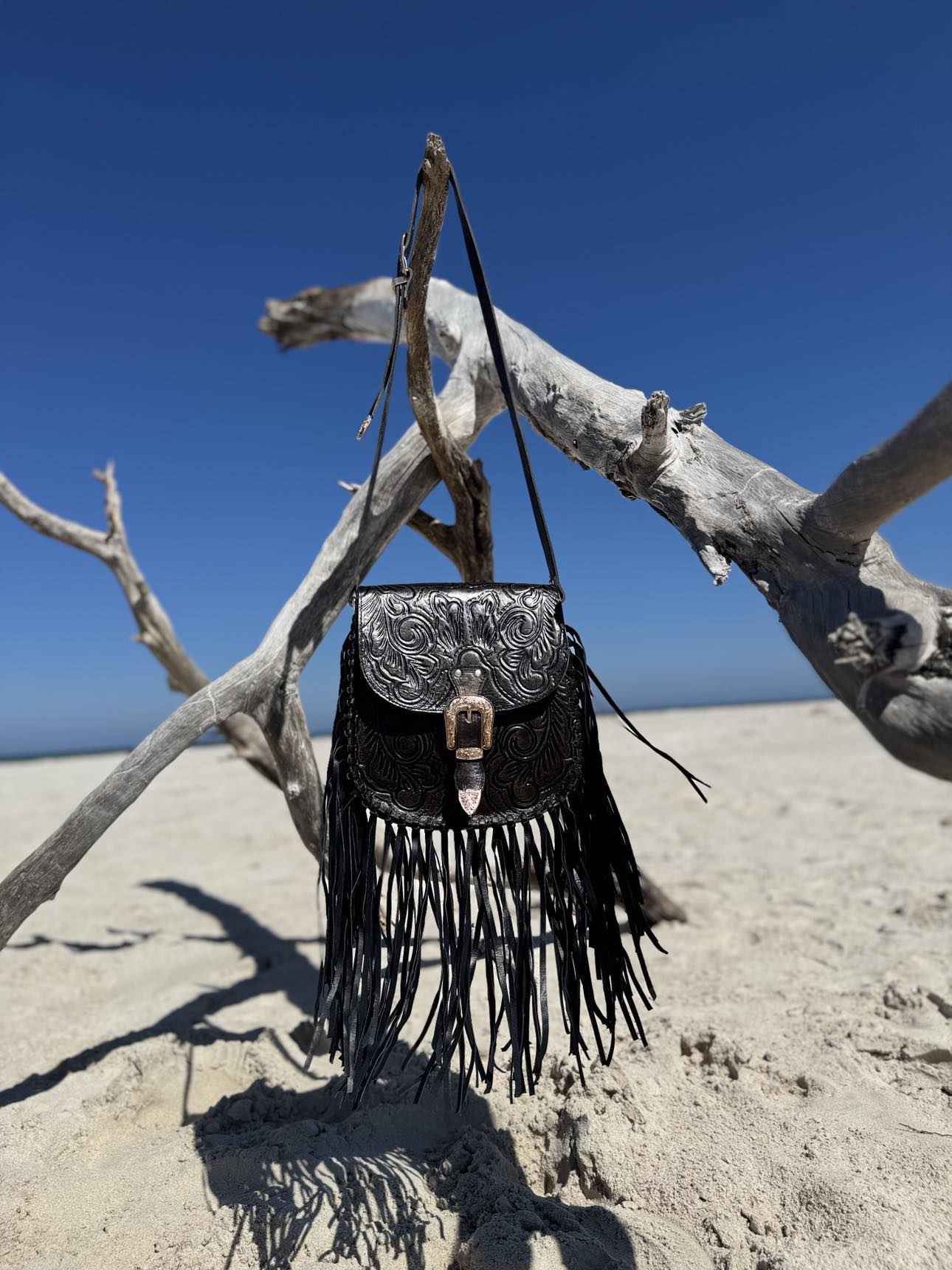 Close-up of the tassels on the Blackstone Crossbody, highlighting their texture and movement.