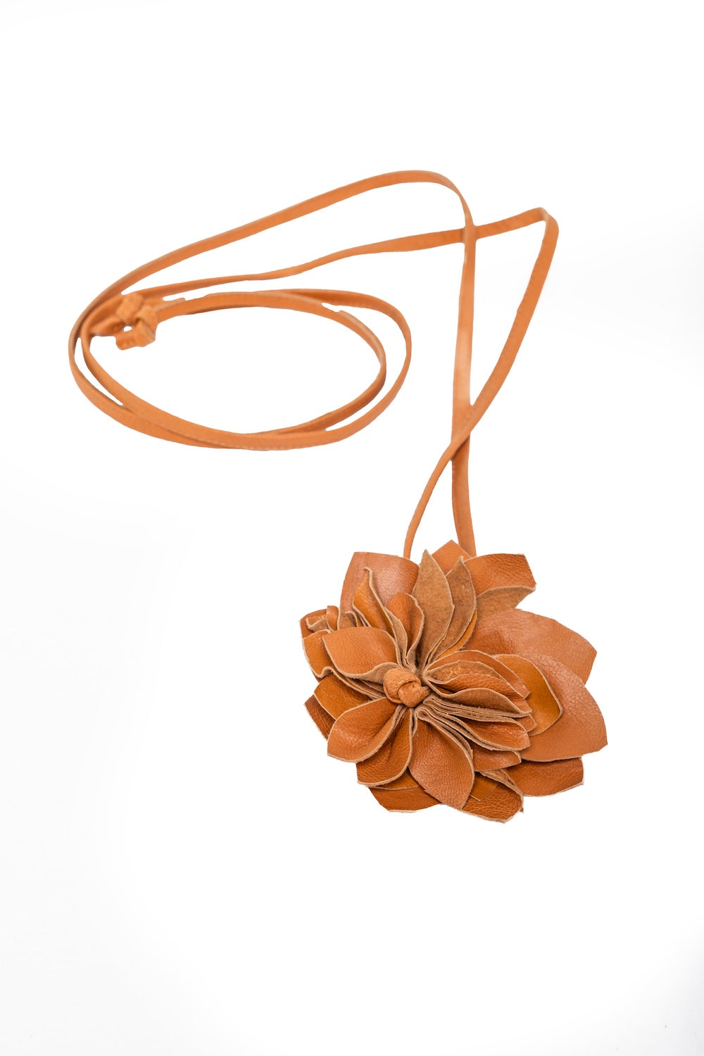 Soft, romantic shot of tan leather flower choker styled with a cream crochet dress—perfect blend of western and boho fashion.
