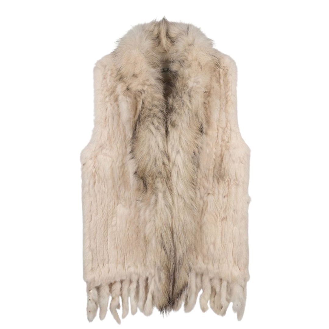 Cottontail Fur Vest from House of Hide in soft neutral beige real rabbit fur with plush raccoon fur collar, fringed hem detail, single button closure, sleeveless silhouette being displayed on neutral background as versatile layering piece for winter styling
