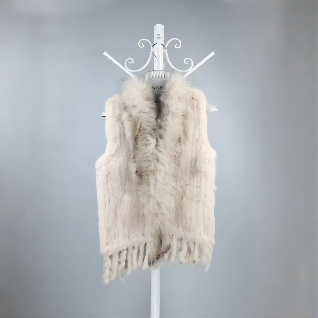 Cottontail Fur Vest from House of Hide in soft neutral beige real rabbit fur with luxe plush raccoon fur collar accent, fringed moving hem, single button front closure, sleeveless knitted construction designed to layer over jumpers, dresses or any outfit for bold edge warmth without bulk