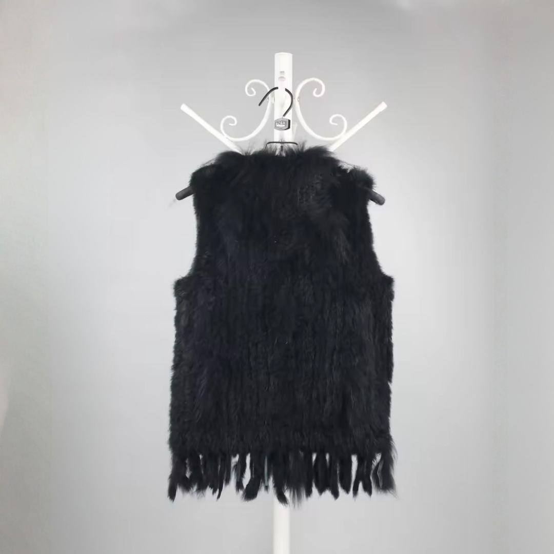 Cottontail Fur Vest from House of Hide in soft real rabbit fur with luxe plush raccoon fur collar accent, fringed moving hem, single button front closure, sleeveless knitted construction designed to layer over jumpers, dresses or any outfit for bold edge winter warmth