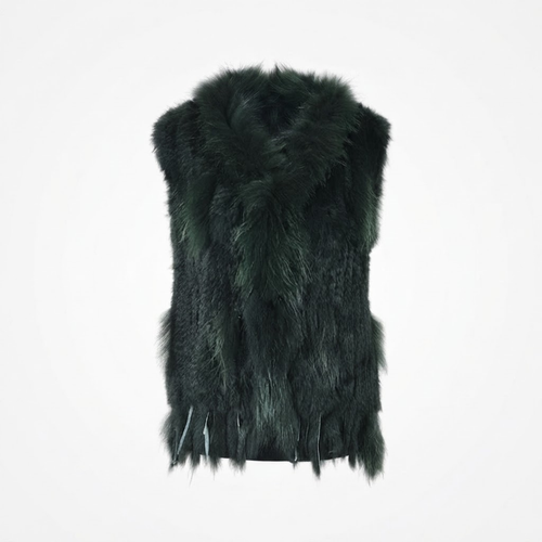 Cottontail Fur Vest from House of Hide in bold deep forest green real rabbit fur with plush raccoon fur collar, fringed hem detail, single button closure, sleeveless silhouette being displayed on neutral background as versatile layering piece for winter styling