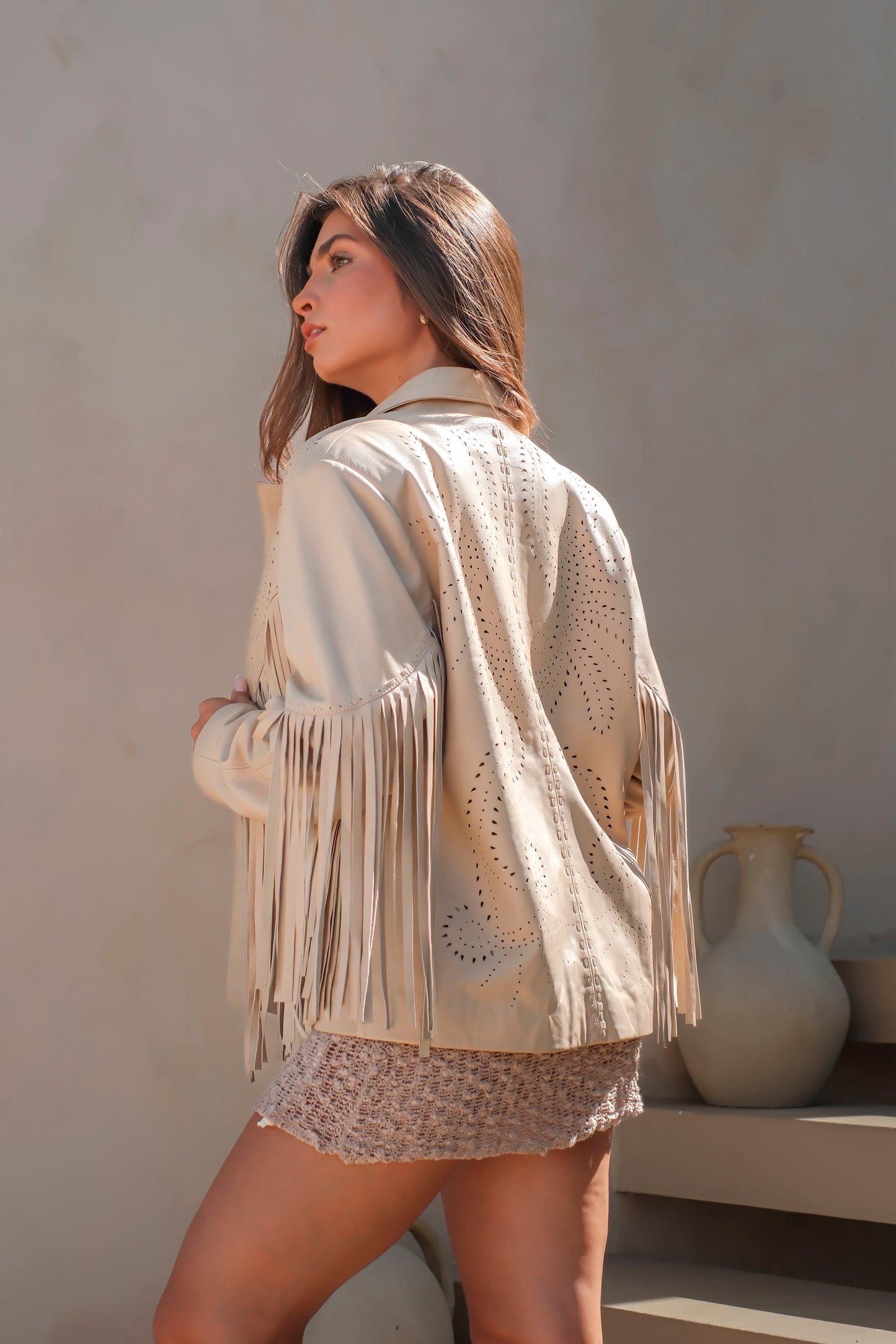 Country-inspired cream leather jacket with fringe trim and relaxed silhouette