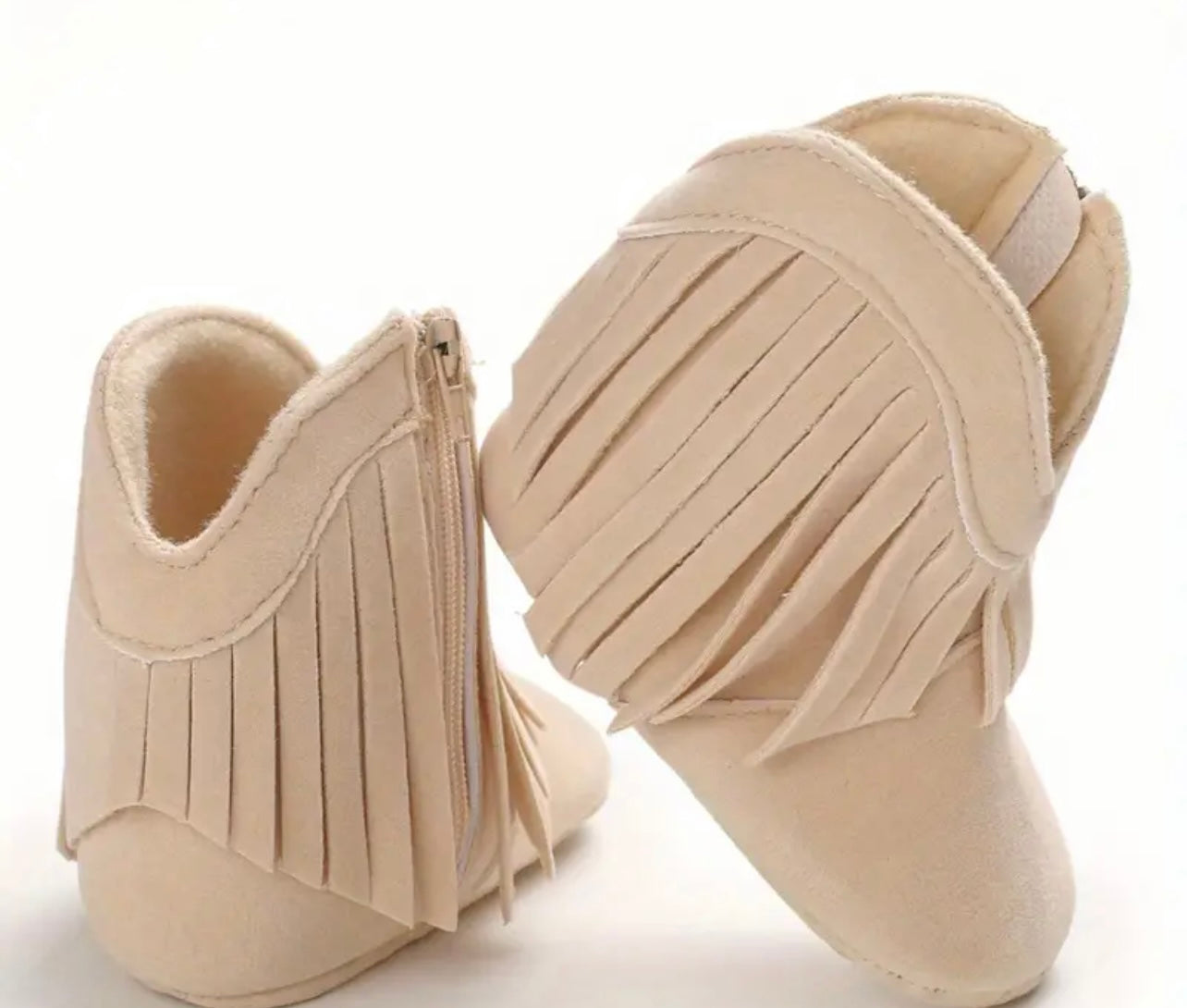 Baby cowboy boots with plush fabric and tassels, designed for warmth and comfort. Available in Beige, Pink, Brown, and Dark Grey for stylish infant footwear.