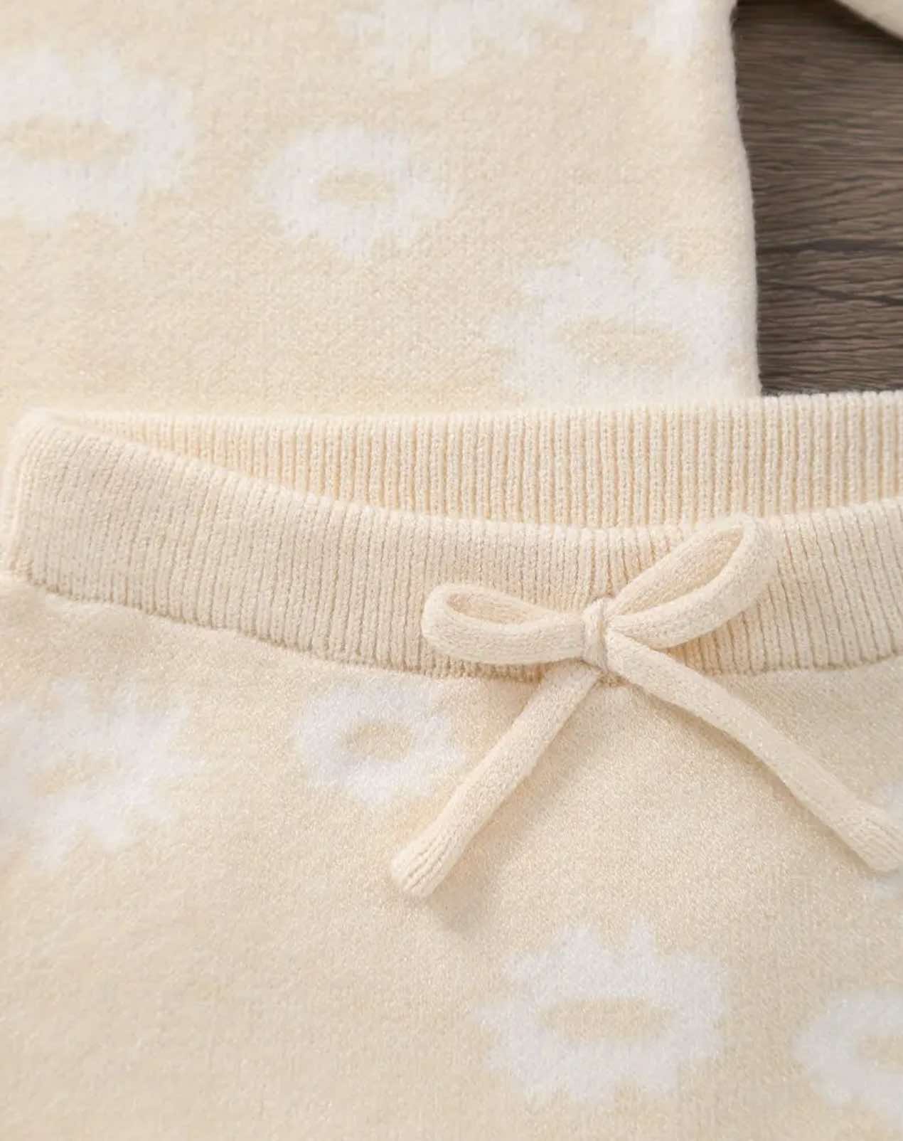 Cream-colored Serafina Baby Set with floral print, made from soft, stretchy fabric.