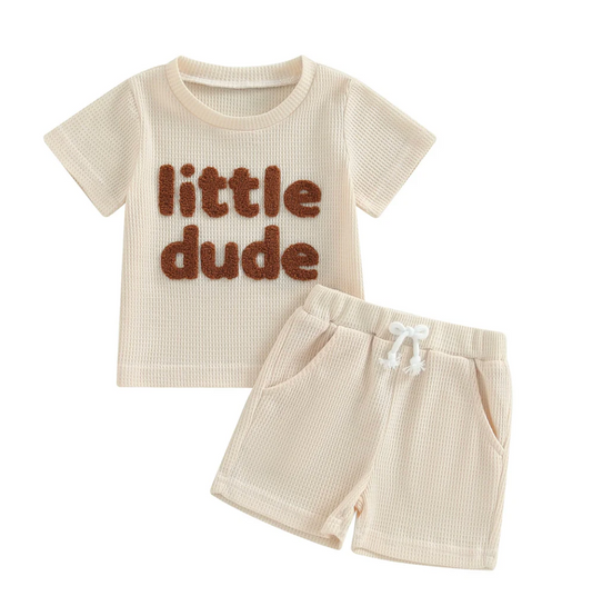 Soft cream top and shorts set with playful embroidery, styled for sunny days and warm-weather adventures.