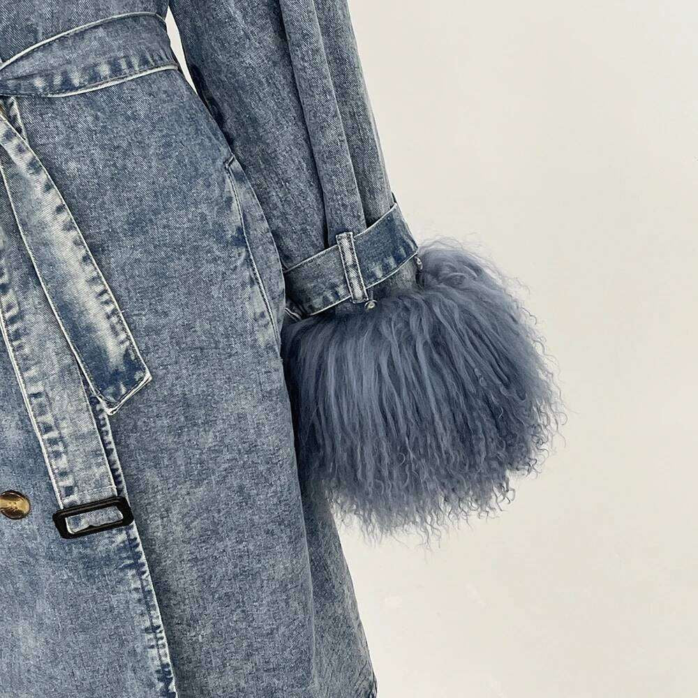 Denim Trench Coat from House of Hide in rugged acid-wash denim featuring plush faux fur collar and cuff accents, adjustable tie belt creating refined shape, classic button-front closure with lapel detail, long silhouette on styled backdrop
