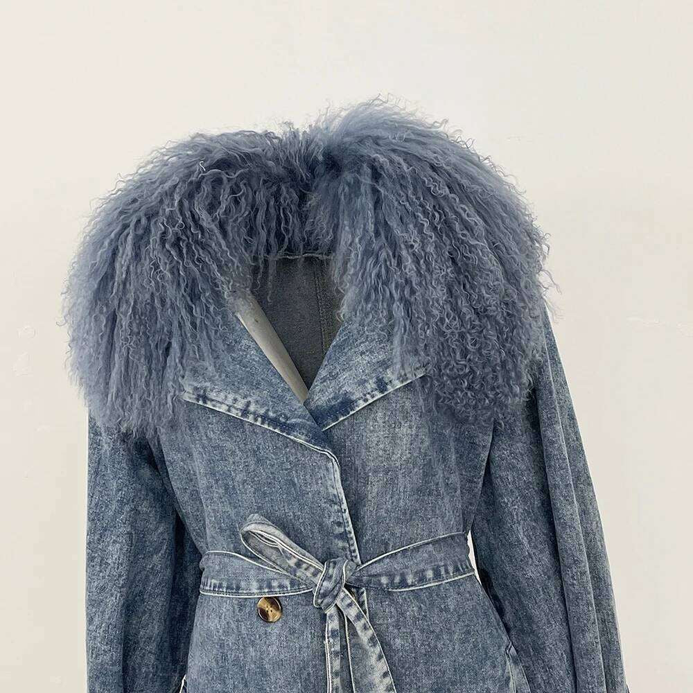 Denim Trench Coat from House of Hide in durable acid-wash denim construction, plush faux fur trim at collar and cuffs, adjustable tie belt for tailored silhouette, classic button-front closure, long layering silhouette being displayed on light background