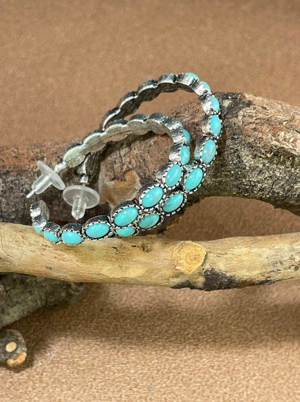 Rustic earrings Australia, half-hoop design with turquoise stones in silver bezels and feather detailing for Western country charm.