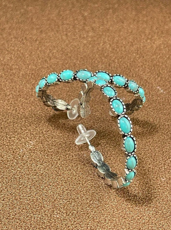 Rustic earrings Australia, half-hoop design with turquoise stones in silver bezels and feather detailing for Western country charm.