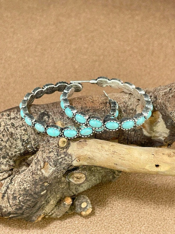Rustic earrings Australia, half-hoop design with turquoise stones in silver bezels and feather detailing for Western country charm.