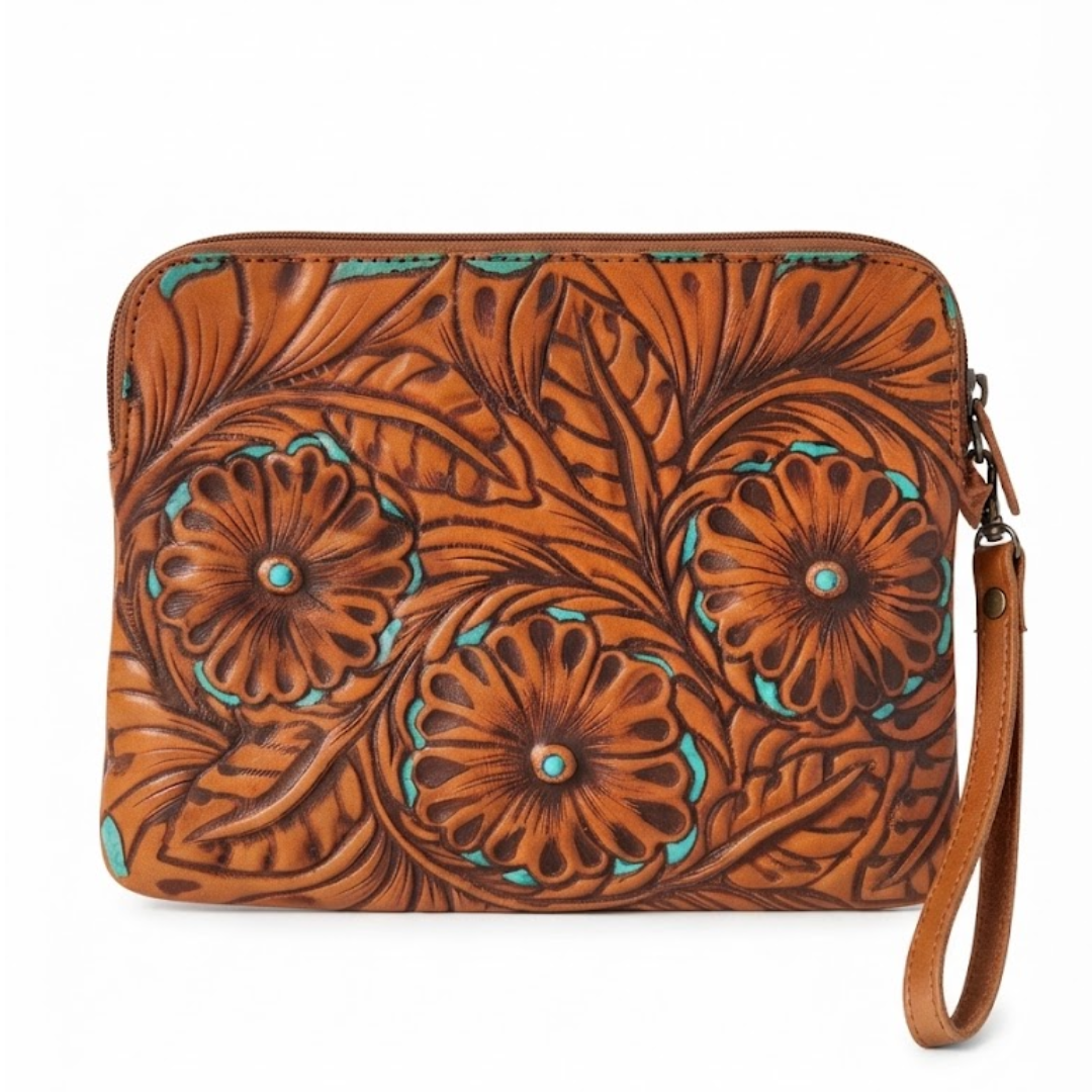 A brown tooled leather wristlet clutch with embossed floral patterns and turquoise accents, featuring a wrist strap and zipper closure on a white background.