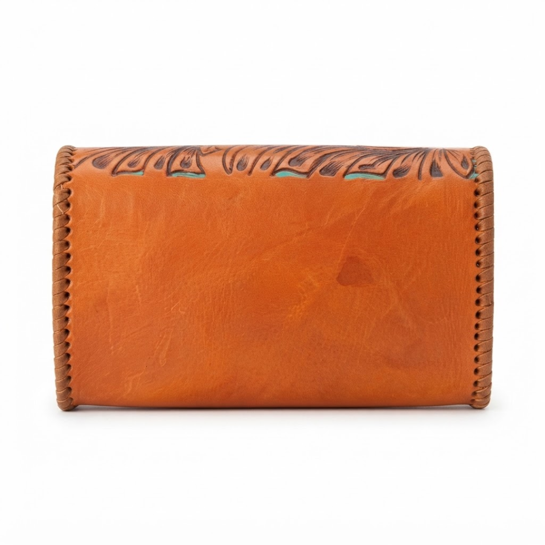 A warm tan leather wallet with hand-tooled floral detailing along the top edge and turquoise-colored accents, shown against a plain white background.