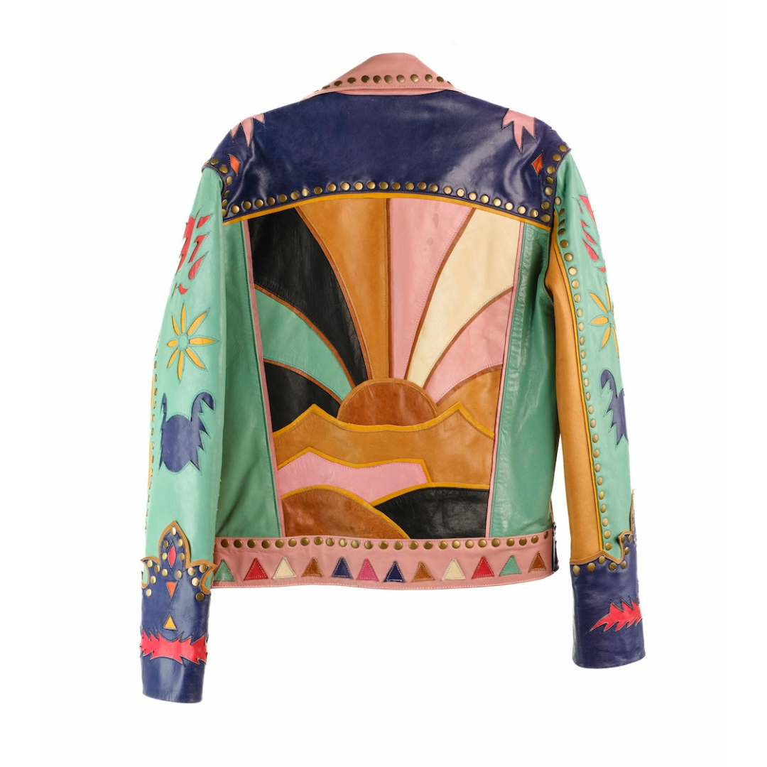 A multicolor hand-painted leather jacket shown from the back, featuring a vibrant sunset design with geometric and animal motifs on a white background.