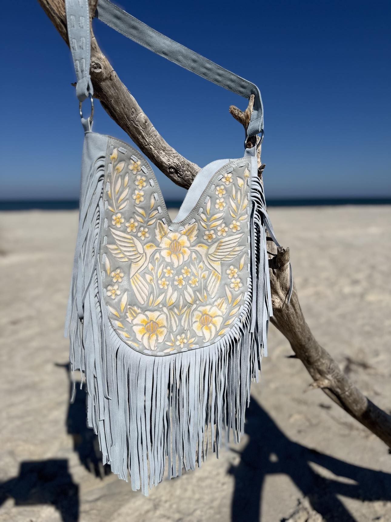 Fringe handbag trend: Blue Blossom Fringe Bag with yellow flowers and western saddle details.