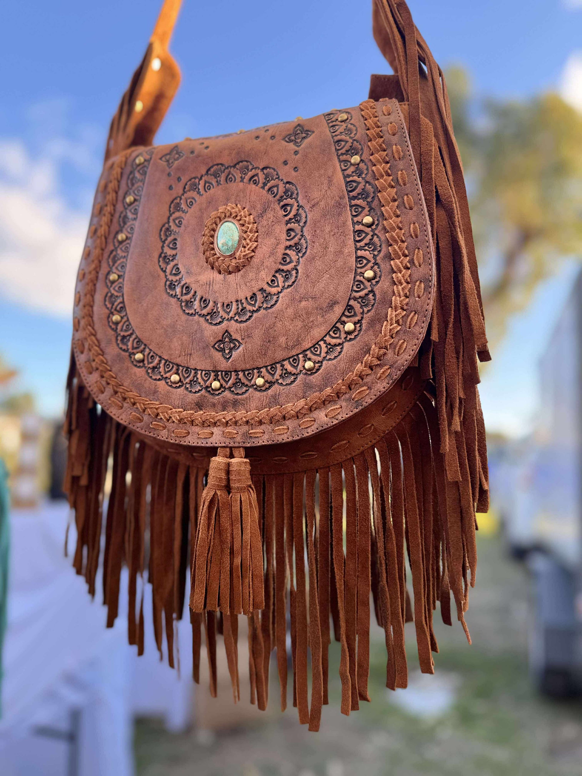 Genuine leather boho crossbody bag with fringe and hand-tooled floral detailing, featuring a turquoise blue stone – Isla Rae