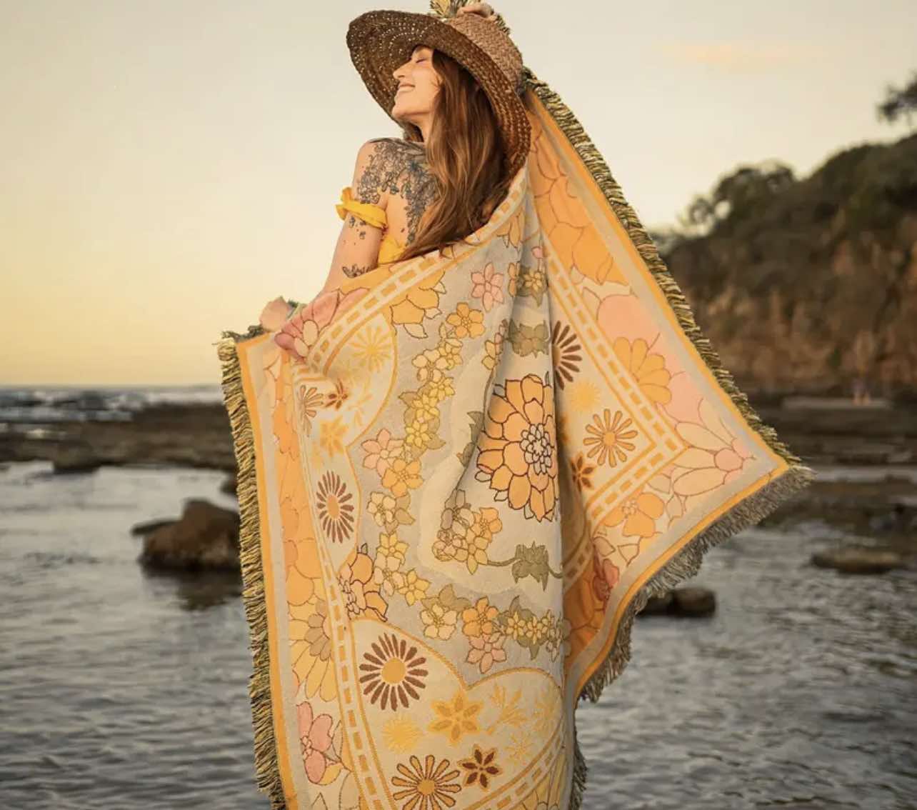 Golden Glow Boho Rug laid out on the beach as a stylish picnic blanket, perfect for boho-themed outings.