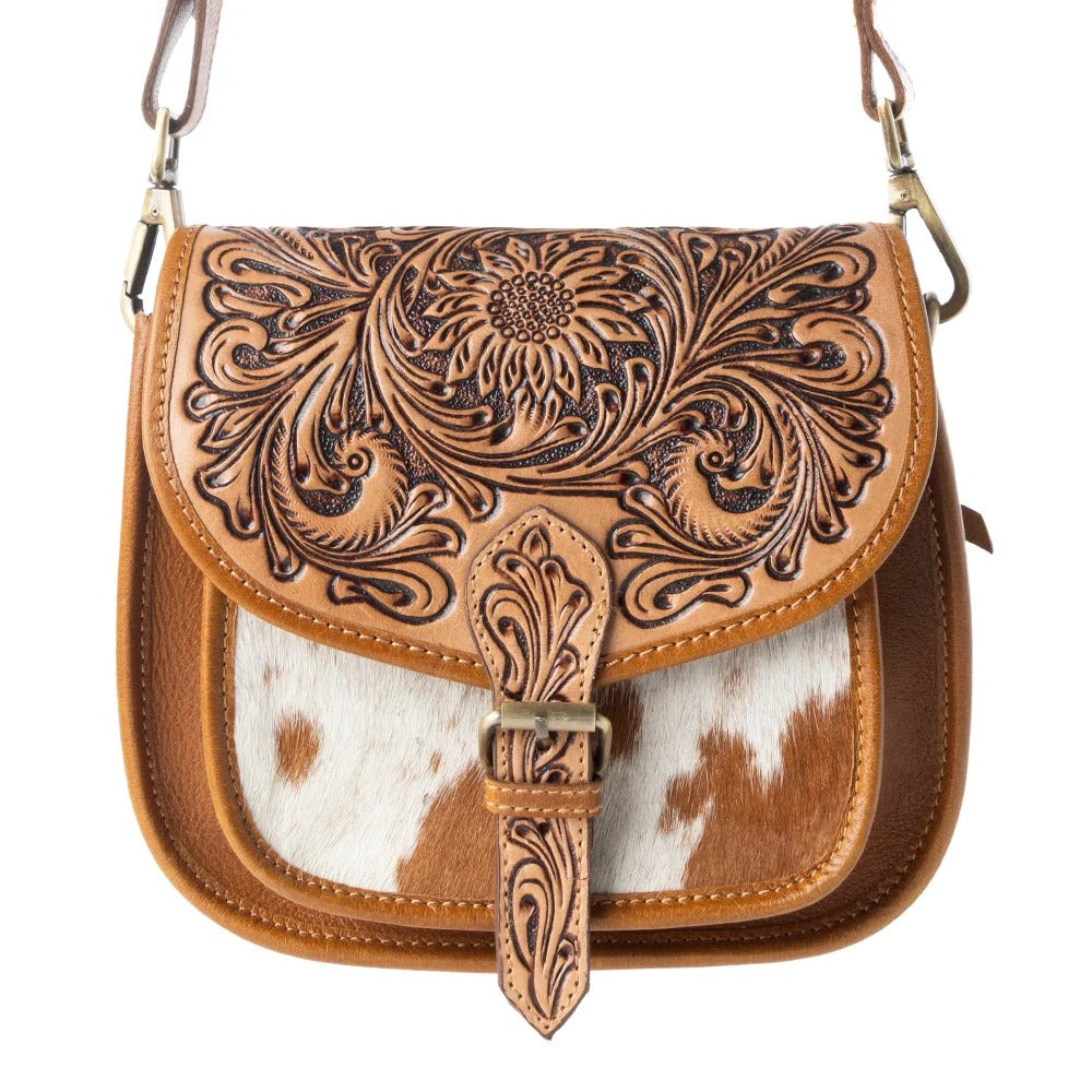 House of Hide genuine leather brown handbag featuring intricate tooled patterns and a distinctive cowhide design on a white background