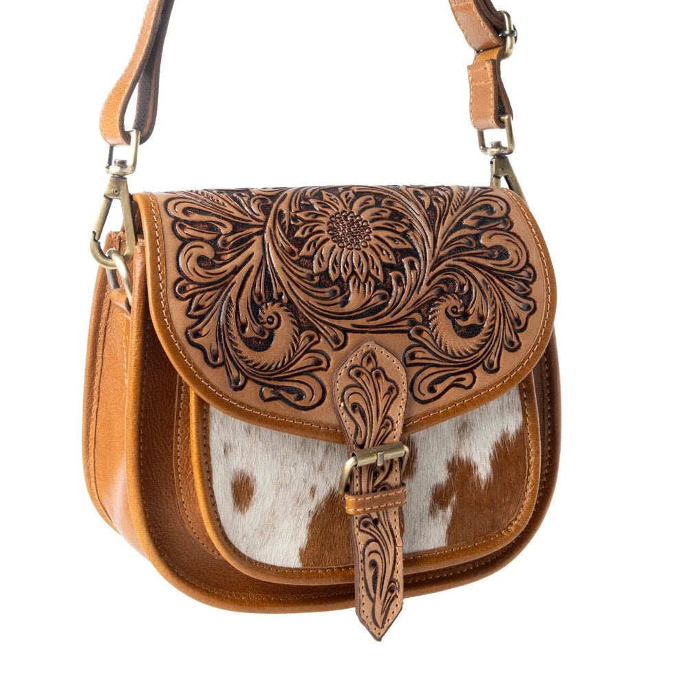 House of Hide genuine leather brown handbag featuring intricate tooled patterns and a cowhide flap detail on a white background