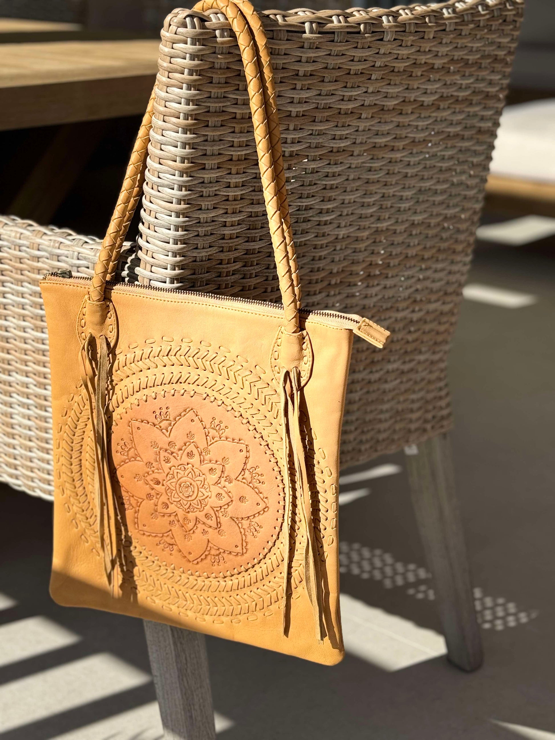 Hand-tooled leather shoulder bag with braided straps, fringe, and a rope handle, "Wildflower," vintage-inspired boho bag.