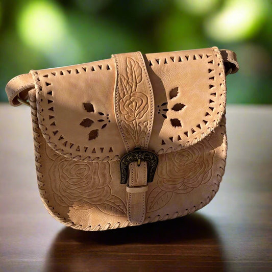 Hand-tooled rustic leather saddle bag, "Desert Rose," crossbody or shoulder bag with floral detailing, adjustable strap, and magnetic close.