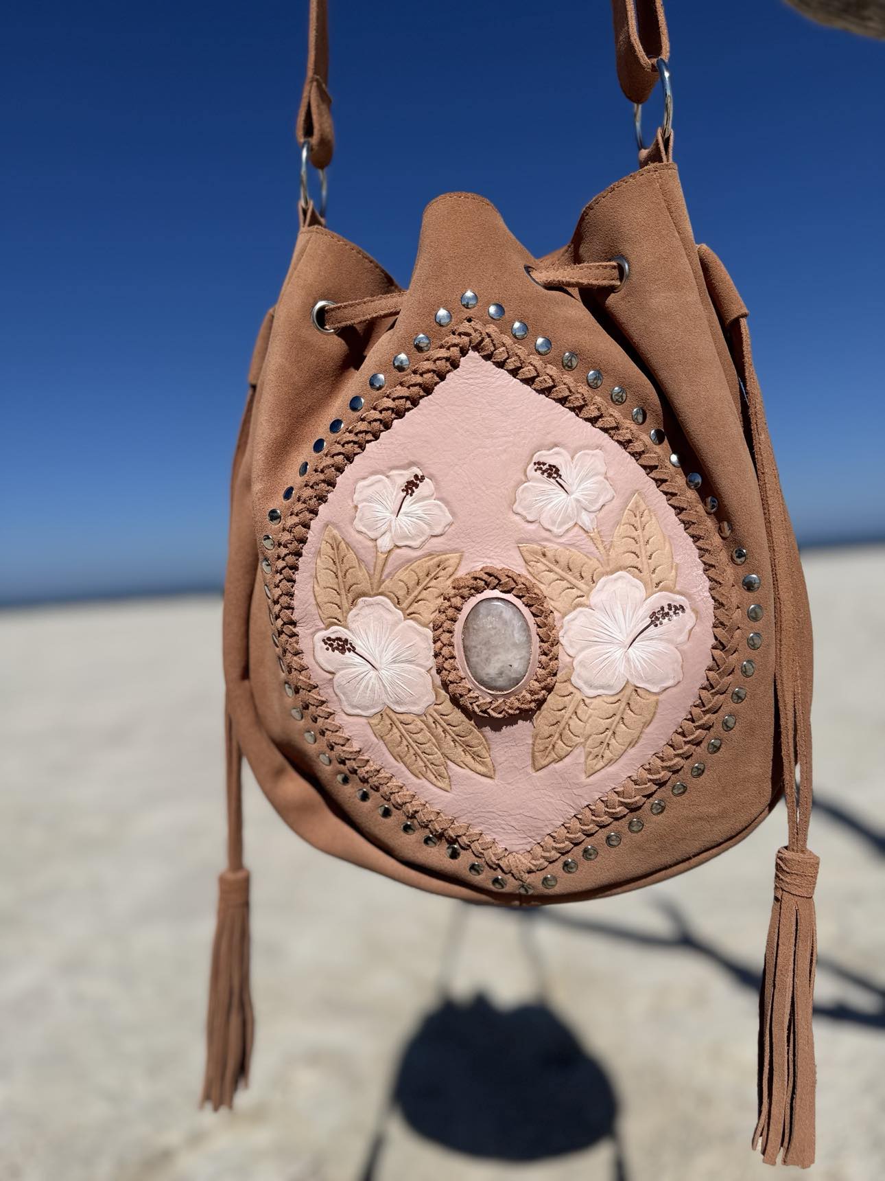 Handcrafted Hibiscus Blush Leather Bag – Unique handmade western-style bag in blush suede, featuring hibiscus flower details and rose quartz stone, ideal for a boho look.