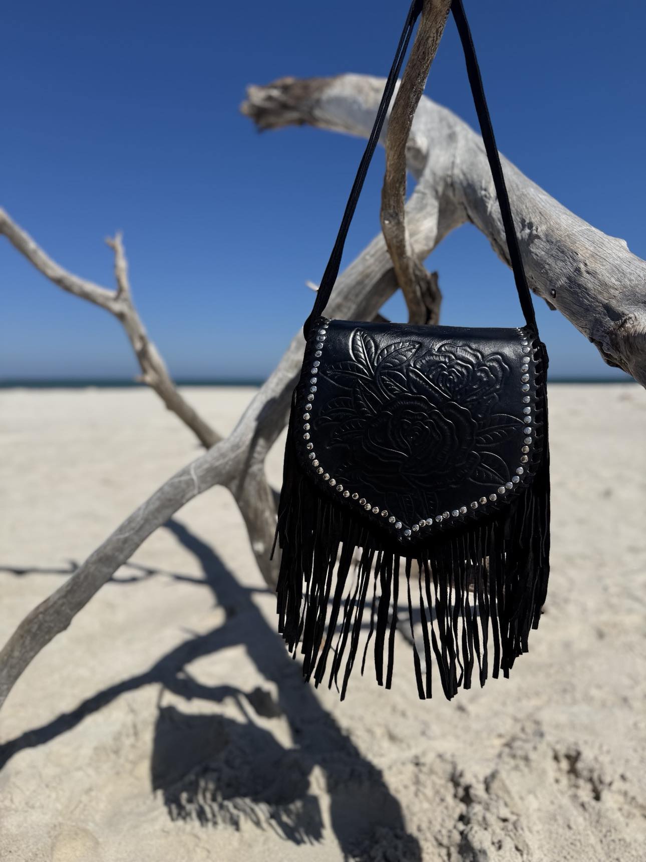 Handcrafted black leather bag with tassels and stones, a must-have boho fringe handbag from House of Hide.