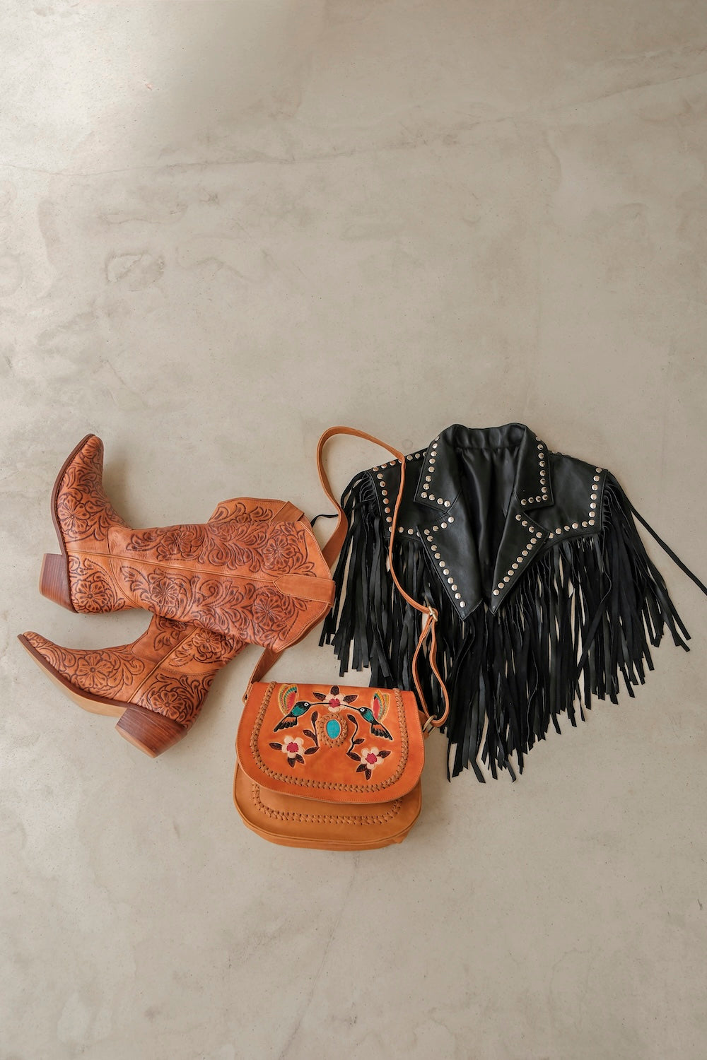 Handcrafted black leather bolero with Western fringe and standout white star. Ethically made jacket for boho, country, and rodeo lovers.