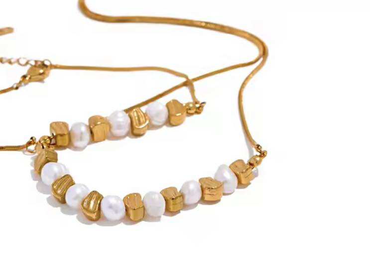 Handmade pearl and gold bracelet styled on wrist with linen outfit – boho country jewellery.