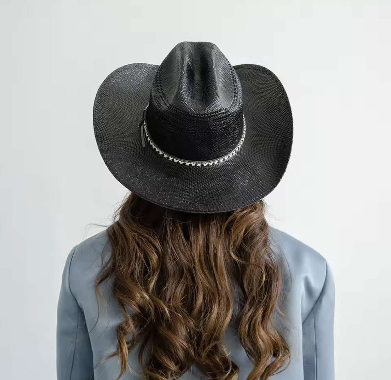 Handwoven black cowboy hat styled for women – side profile with elegant crown shape