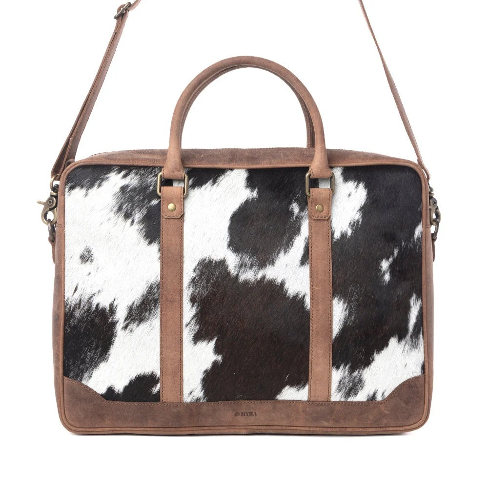 House of Hide genuine leather western handbag featuring a brown and white cow print with premium brown leather accents on a white background