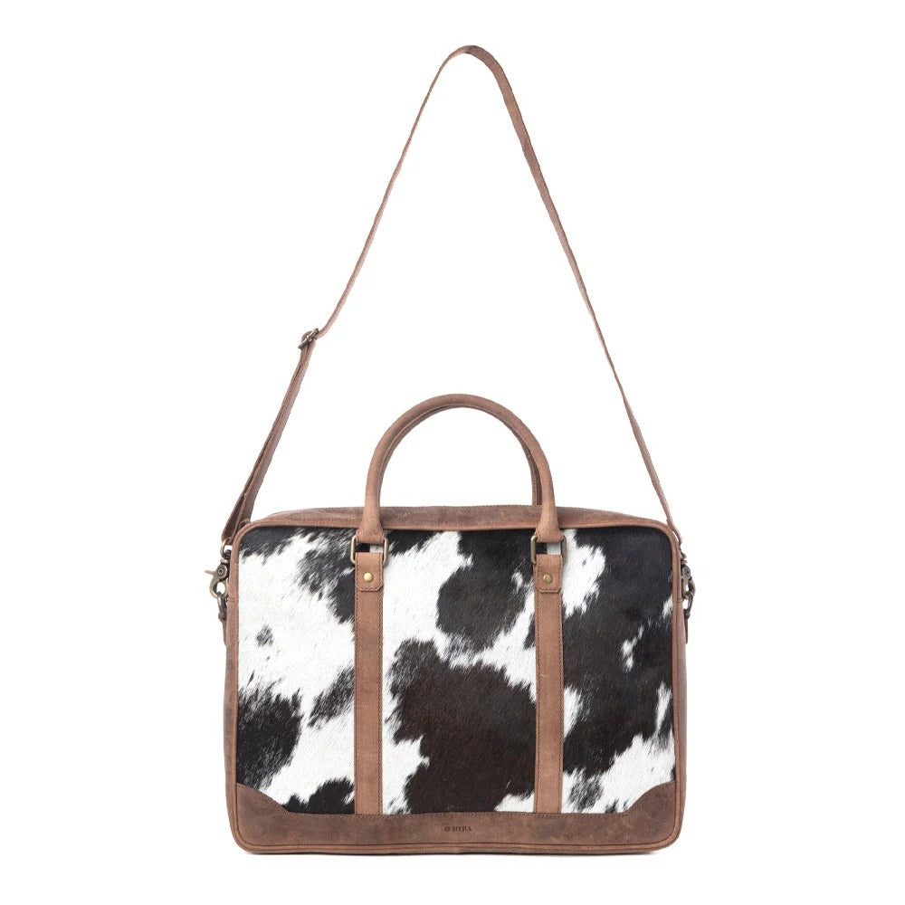 House of Hide handcrafted genuine leather cow print handbag featuring premium brown leather accents on a white background
