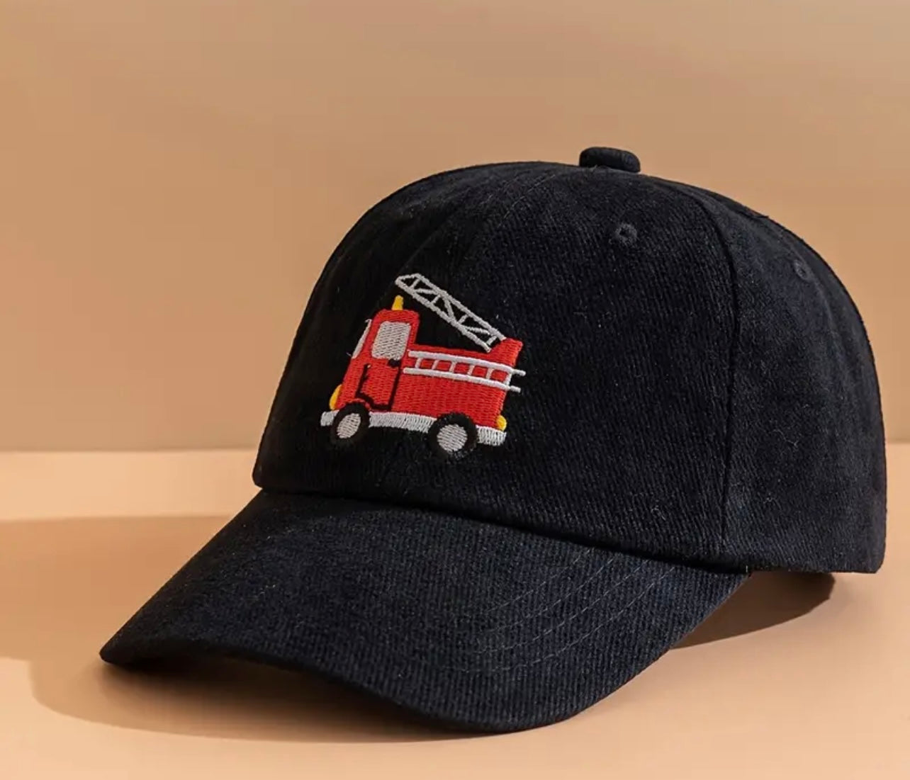 Top view of the kids' firetruck hat, displaying its soft fabric and sturdy construction, perfect for all-day wear